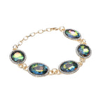 Grünes Glaskristall Armband und Ohringe, goldfarben